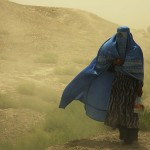 Frau mit Burka im Sandsturm